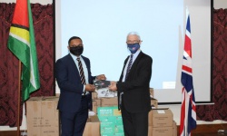 Hon. Vickram Bharrat receiving the contribution from H.E Ray Davidson