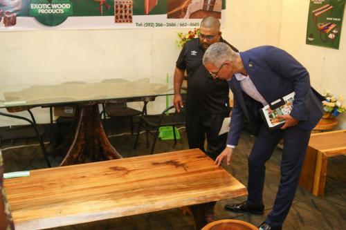 Minister of Business Dominic Gaskin inspects a table